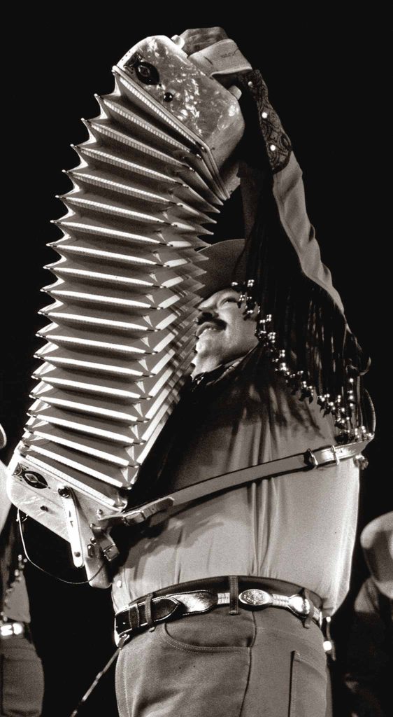 Black and white photo of man playing accordion.