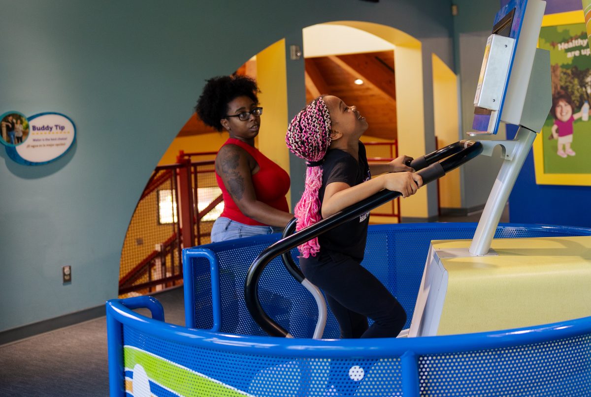 young girl uses stair climber machine