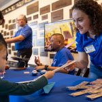 young girl is helped by community partner.